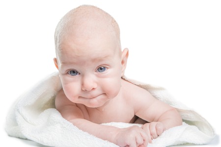 Caucasian baby covered with towelの写真素材