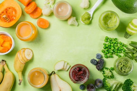 Colorful baby food purees in glass jarsの写真素材