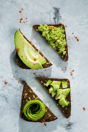 Avocado toasts on marble background