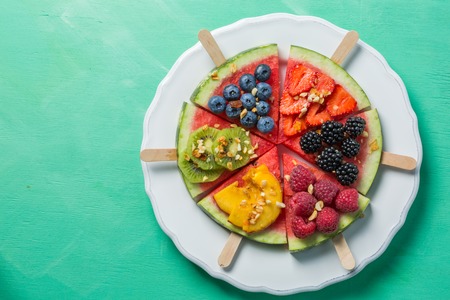 Watermelon pizza - slices with berries and fruits, granola. Fresh low carb diet