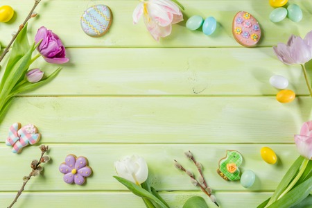Easter concept - cookies with flowers on green wood backgroundの写真素材
