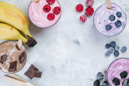 Healthy vegan dessert concept - smoothie bowl made of frozen banana and berries