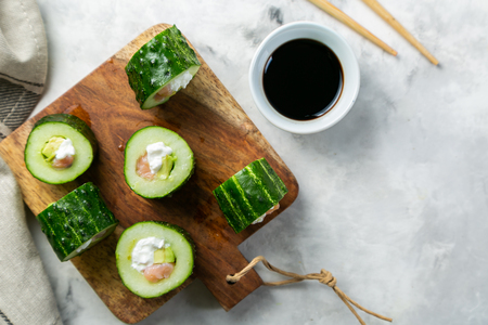Low carb sushi alternative - cucumber sushi with salmon and avocadoの写真素材