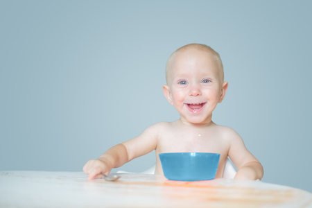 Baby eating and smiling, isolatedの写真素材