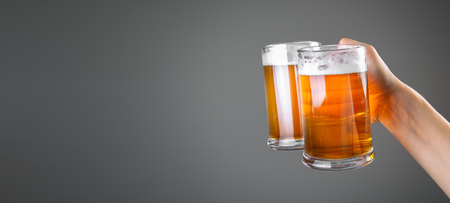 Oktoberfest concept - hand holding glasses with beerの写真素材