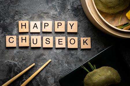 Chuseon day concept, korean thanksgiving day - songpyeon rice cakes on rustic backgroundの写真素材