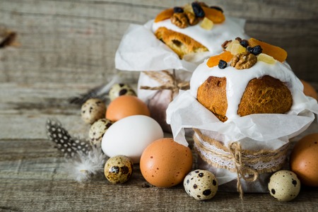 Easter cakes with eggs, rustic wood background