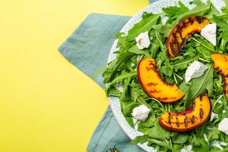 Summer salad - arugula with grilled peaches, cheeseの写真素材