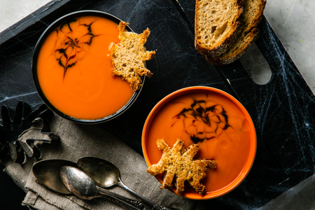 Halloween style pumpkin soup - with spider shaped toastの写真素材