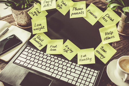 New year resolutions concept - resolutions on paper notes with calendar