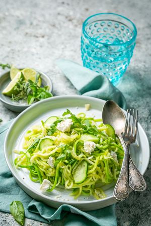 Zucchini noodles with cucumber, feta cheese and arugulaの写真素材