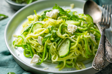 Zucchini noodles with cucumber, feta cheese and arugulaの写真素材