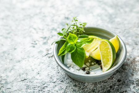 Fresh hearbs and lime on rustic backgroundの写真素材