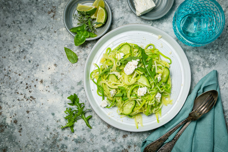 Zucchini noodles with cucumber, feta cheese and arugulaの写真素材