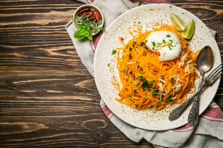 Butternut squash noodles with mozzarela, pecans, herbsの写真素材