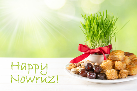 Nowruz holiday concept - grass, baklava sweets, nuts and seedsの写真素材