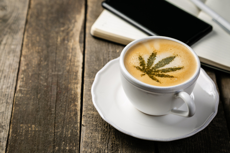 Cannabis coffee - marijuana leaf on coffee foamの写真素材