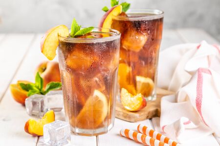 Lemon and peach iced tea on wooden backgroundの写真素材