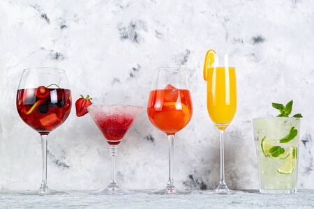 Selection of refreshing summer drinks - mojito, sangria, mimosa, aperol, martini, rustic background copy spaceの写真素材
