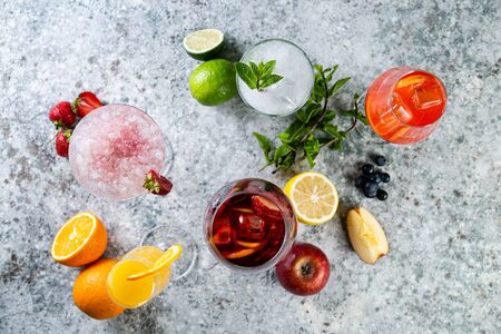 Selection of refreshing summer drinks - mojito, sangria, mimosa, aperol, martini, rustic background copy spaceの写真素材