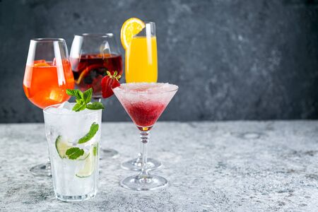 Selection of refreshing summer drinks - mojito, sangria, mimosa, aperol, martini, rustic background copy spaceの写真素材