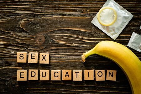 Sex education concept - letters, banana and condoms on wood backgroundの写真素材
