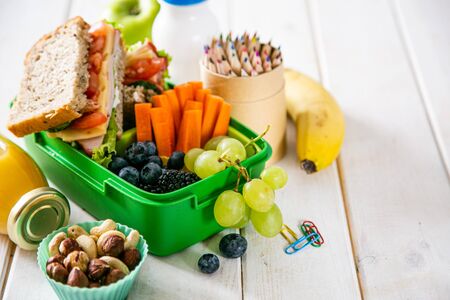 Back to school concept - lunch box with juice, apple and bananaの写真素材