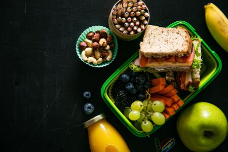 Back to school concept - lunch box with juice, apple and bananaの写真素材