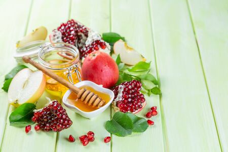 Rosh hashana jewish holiday concept - apples, honey, pomegranateの写真素材