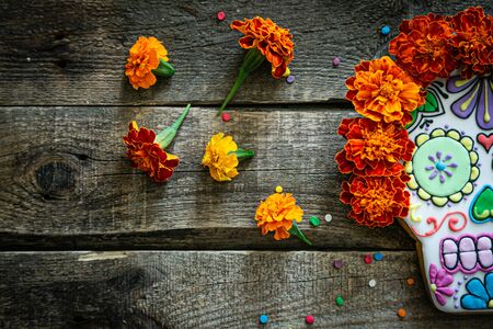 Day of the dead concept dia de los muertos - skull shapes cookie with marigold flowersの写真素材