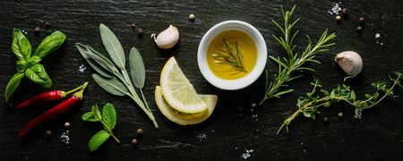 Selection of herbs and spices on black background, top viewの写真素材