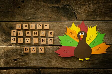 Thanksgiving paper craft - thanksful turkey on wood background