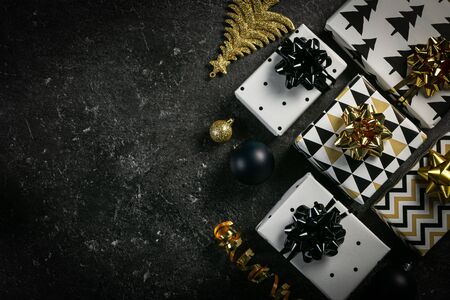 Christmas concept - black and golden presents and decorations