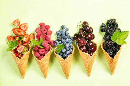 Selection of berries in ice cream conesの写真素材