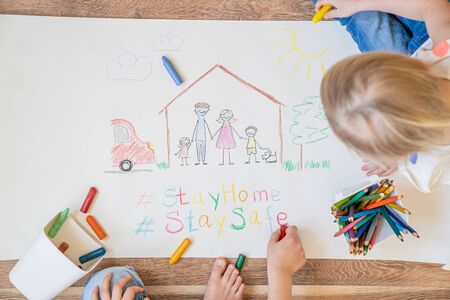 Kids drawing family wearing face masks - covid concept, stay home and stay safeの写真素材
