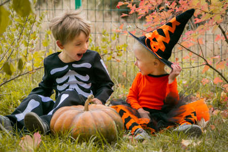 Halloween concept - boy and girl in the fall gardenの写真素材