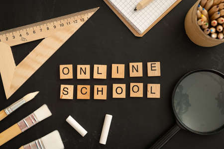Online school class cover - celection of stationery on black boardの写真素材