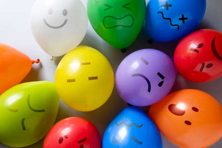 Mental health concept - selection of emojis on colorful balloons for different mental states