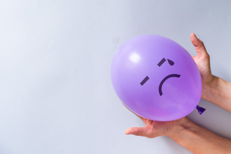 Mental health concept - purple balloon with depression emojiの写真素材