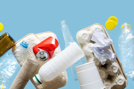 Recycling concept - levitation of recyclable materials on bright background