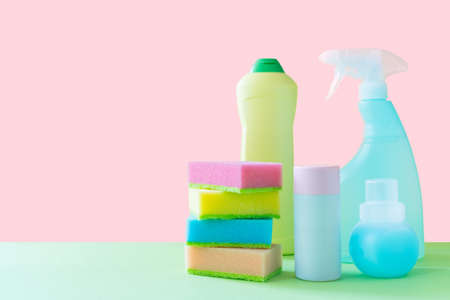 Cleaning concept - cleaning supplies on pastel yellow backgroundの写真素材