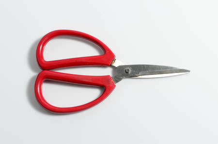 Old red scissors isolated on white backgroundの写真素材