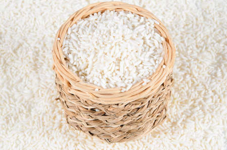 Basket of rice isolated on white backgroundの写真素材