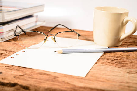 Coffee Cup and office supplies on old wood tableの写真素材