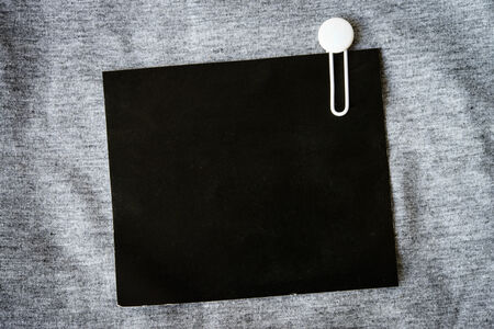 close up of grunge black paper note on gray backgroundの写真素材