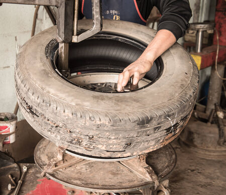Mechanic changing a car tire closeupのeditorial素材