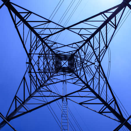 High voltage towers with sky . blue toned images.