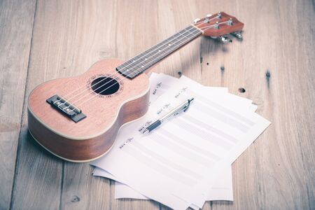Ukulele and musical paper notes,vintage tone style