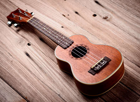 ukulele on wood backgroundの写真素材