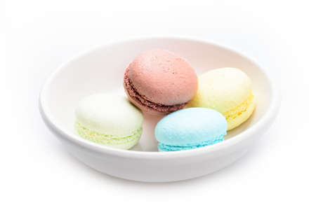 A lot of french colorful macarons The plate on a white backgroundの写真素材